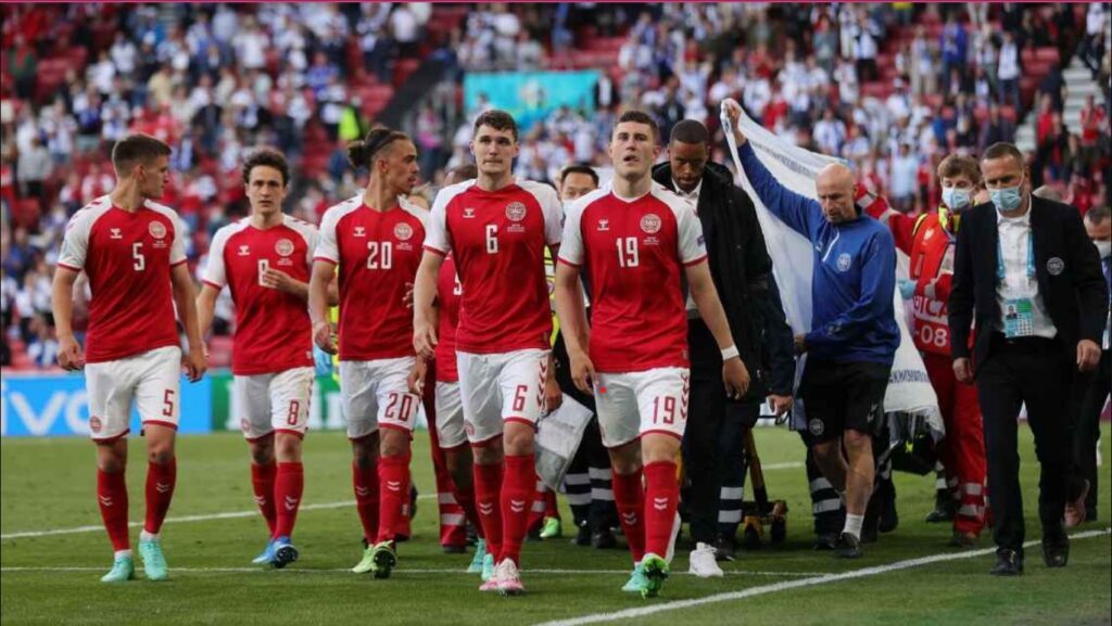 Christian Eriksen is shielded by his Denmark teammates after collapsing during the Euro 2020